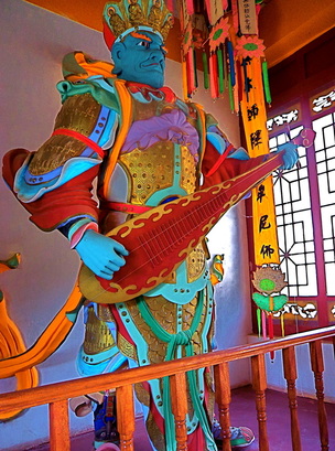 Chinese temple warrior playing a guitar